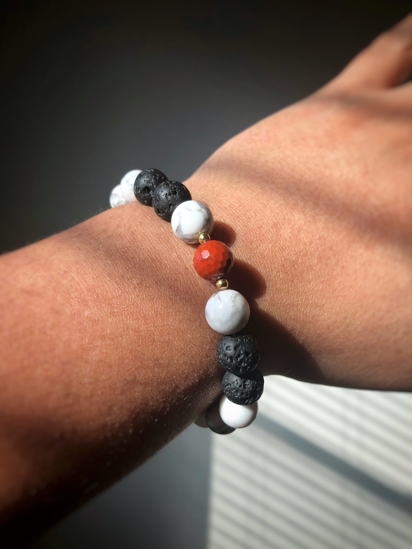 "Lightning Count" - Lava Stone, Howlite, White Jade, Faceted Red Jasper with Gold Brass Spacer Bead